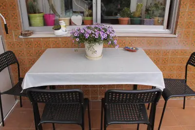 a table with a vase of flowers on it at Suite Porto in Porto