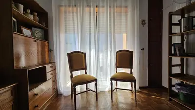 two chairs sitting in a room with a window at Suite Porto in Porto