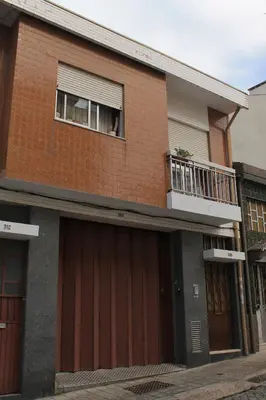 a brick building with a dog sticking its head out of a window at Suite Porto in Porto