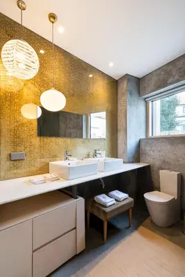 a bathroom with two sinks and a toilet at Charm Palace Porto in Porto