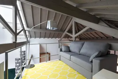 a living room with a couch in a loft at Charm Palace Porto in Porto