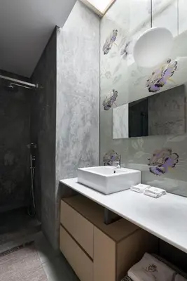 a bathroom with a white sink and a shower at Charm Palace Porto in Porto