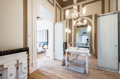 a bathroom with a sink and a mirror at Charm Palace Porto in Porto