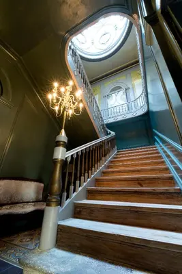 a staircase in a building with a chandelier at Charm Palace Porto in Porto