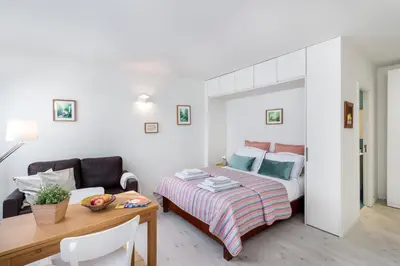 a bedroom with a bed and a table and a couch at Formosa Flats in Porto