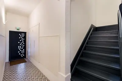 a staircase in a building with a black stair case at Formosa Flats in Porto