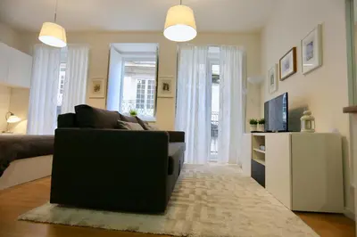 a living room with a couch and a television at D&S - Porto São Bento Apartments II in Porto