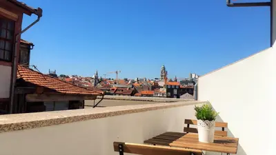 a bench on a balcony with a view of a city at D&S - Porto São Bento Apartments II in Porto