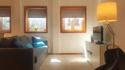 a living room with a couch and two windows at D&S - Porto São Bento Apartments II in Porto