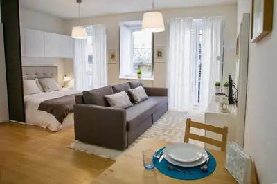 a living room with a couch and a bed and a table at D&S - Porto São Bento Apartments II in Porto