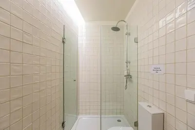 a bathroom with a shower and a toilet in it at Monchique´s Balcony in Porto