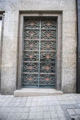 a large metal door on the side of a building at the5rooms.porto in Porto