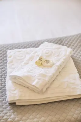 a pair of rings sitting on a pillow on a bed at the5rooms.porto in Porto
