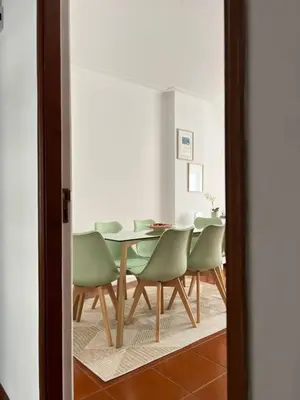 a dining room with a table and green chairs at Douro & Sea - River Side in Vila Nova de Gaia