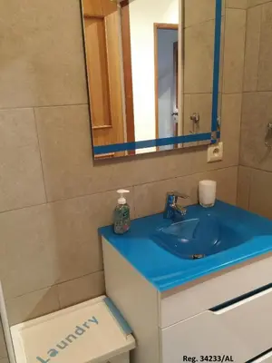 a bathroom with a blue sink and a mirror at Douro & Sea - River Side in Vila Nova de Gaia