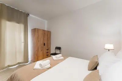a bedroom with a bed with two towels on it at Casa Trindade in Porto