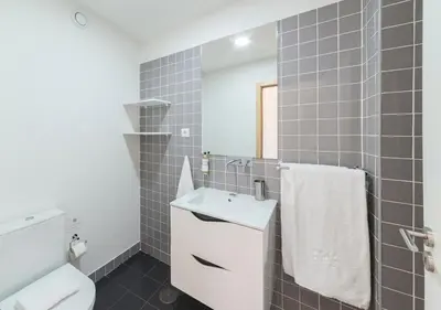 a bathroom with a sink and a toilet and a mirror at Oporto Street Sá de Noronha in Porto