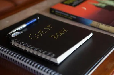 a notebook with the word exam on it next to a pen at Avenida Apartment by MP in Vila Nova de Gaia