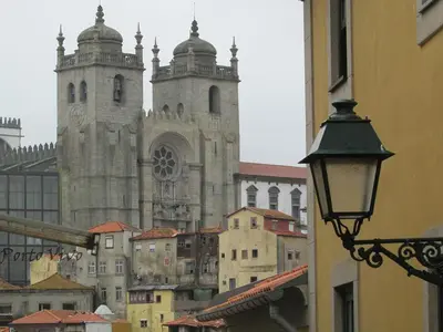 a building with two towers and a street light at PortoVivo Bonjardim Apartamento in Porto