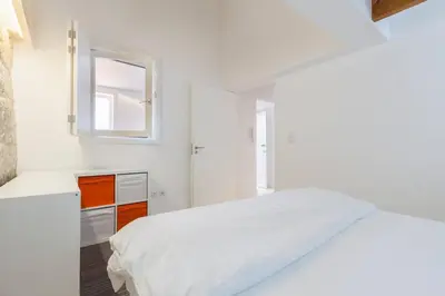 a white bedroom with a bed and a mirror at Boutique Rentals - Hidden Treasure in Porto