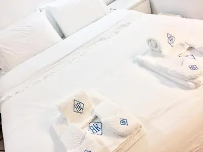 a white bed with towels on it at Boutique Rentals - Hidden Treasure in Porto
