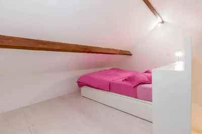 a small bedroom with a bed in a attic at Boutique Rentals - Hidden Treasure in Porto