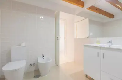 a white bathroom with a toilet and a sink at Boutique Rentals - Hidden Treasure in Porto