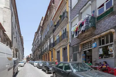 a street with cars parked on the side of a building at Boutique Rentals - Hidden Treasure in Porto