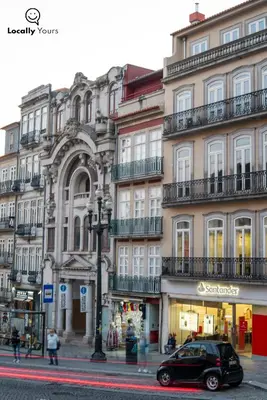 a car parked in front of a building at Locally Yours São Bento Apartments in Porto