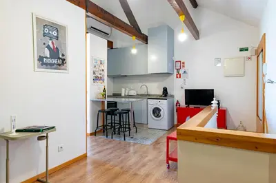 a small bedroom with a bed and a window at Antero Quental Residence in Porto
