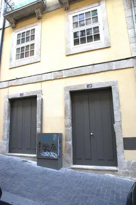 three garage doors on the side of a building at Janika's Apartment in Porto