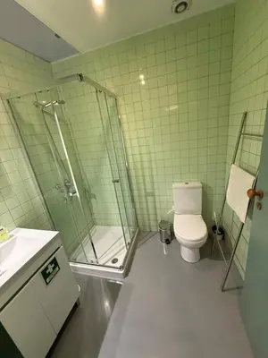 a bathroom with a shower and a toilet and a sink at Well.Come.Porto in Porto