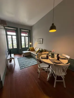 a living room with a table and a couch at Well.Come.Porto in Porto