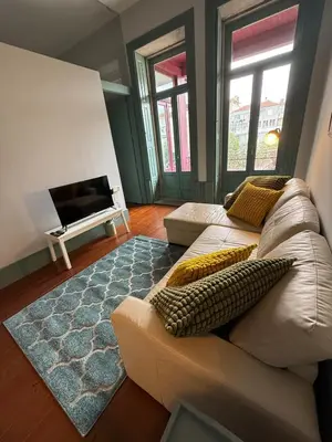 a living room with a couch and a fireplace at Well.Come.Porto in Porto