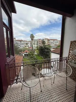a balcony with two chairs and a view of a city at Well.Come.Porto in Porto