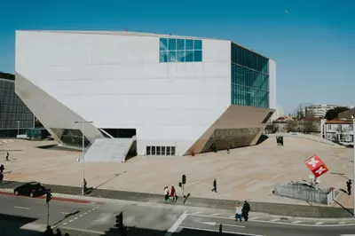 a large building with people walking in front of it at Five Seven Nine Apartments in Porto