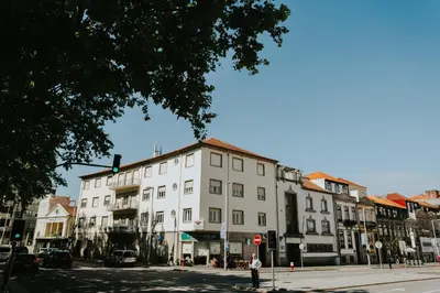 a large white building on a city street at Five Seven Nine Apartments in Porto