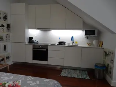 a kitchen with white cabinets and a stove at Oporto Downtown Apartment in Porto