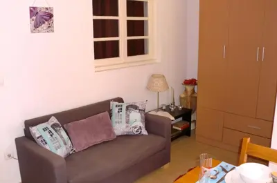 a living room with a couch and a table at The Yellow House in Vila Nova de Gaia