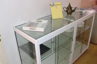 a glass shelf with a box on top of it at The Yellow House in Vila Nova de Gaia