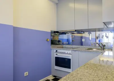 a kitchen with white cabinets and a sink at BOUTIQUE RENTALS - Provence Apartment in Porto