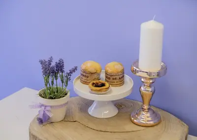 a candle and a plate of food on a table at BOUTIQUE RENTALS - Provence Apartment in Porto