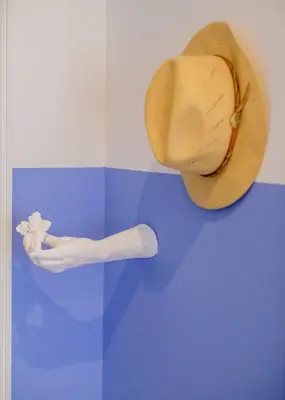 a cowboy hat on a wall with a persons leg at BOUTIQUE RENTALS - Provence Apartment in Porto