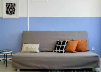a couch with pillows on it in a room at BOUTIQUE RENTALS - Provence Apartment in Porto