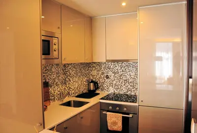 a kitchen with white cabinets and a sink at PicPorto Apartment in Porto
