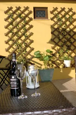 a bottle of wine and two glasses on a table at The Yellow House 2 in Porto