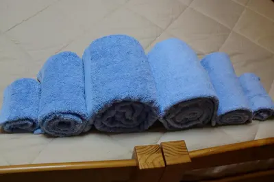 a group of blue towels sitting on a shelf at The Yellow House 2 in Porto
