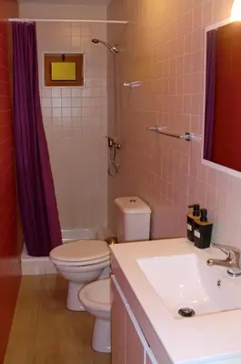 a bathroom with a toilet and a sink and a shower at The Yellow House 2 in Porto