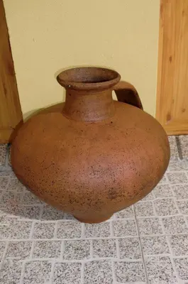 a large brown vase sitting on a tile floor at The Yellow House 2 in Porto