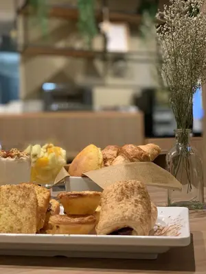 a plate of bread and pastries on a table at Spot Apartments Ceuta in Porto